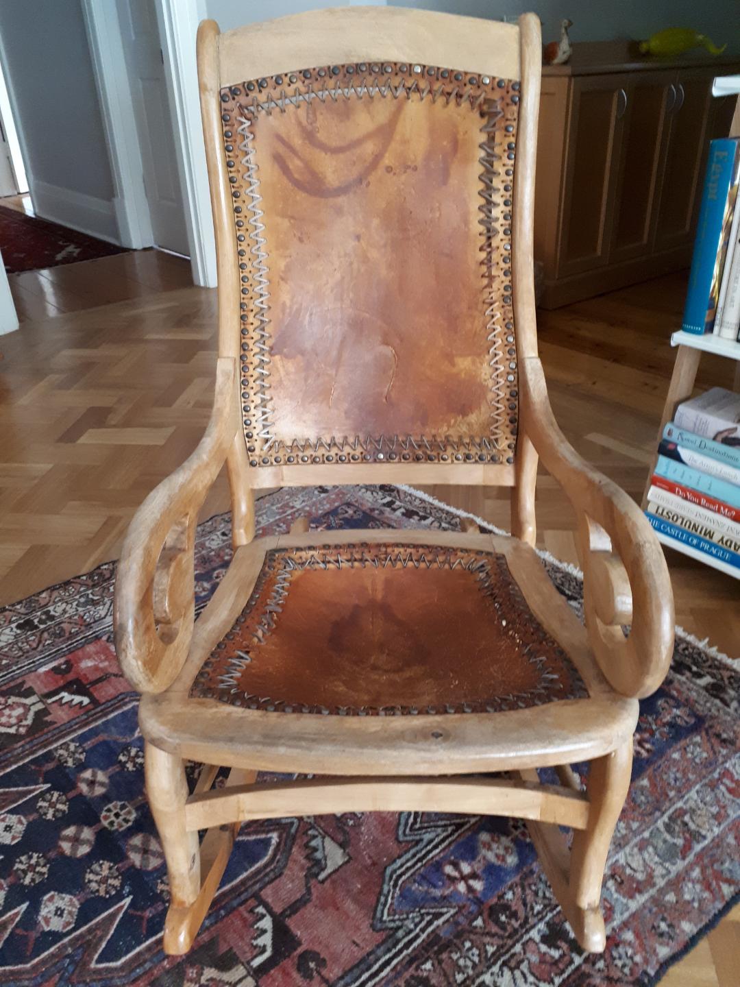 Antique rocking chair with worn leather - before restoration